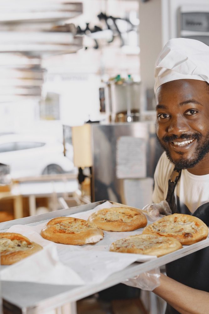 shot-handsome-baker-putting-trays-fresh-bread-stand-baking-manufacture-african-american